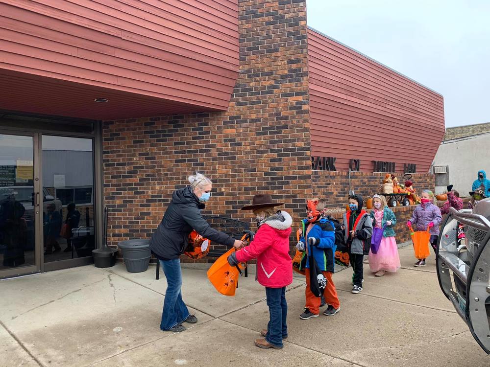 Students trick-or-treating at the local bank
